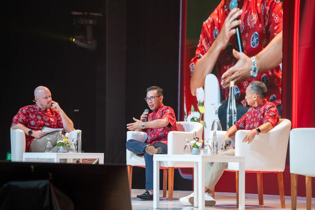 Moderator and panelists in discussion on stage